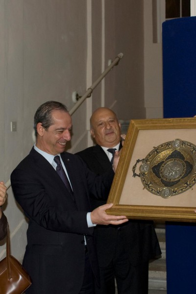 Sir David presenting a gift to the prime minister of Malta, Mr. Lawrence Gonzi at the opening of the exhibition 'Metal Magic: Spanish Treasures from the Khalili Collection' at The Auberge de Provence, Valetta, Malta, November 2011